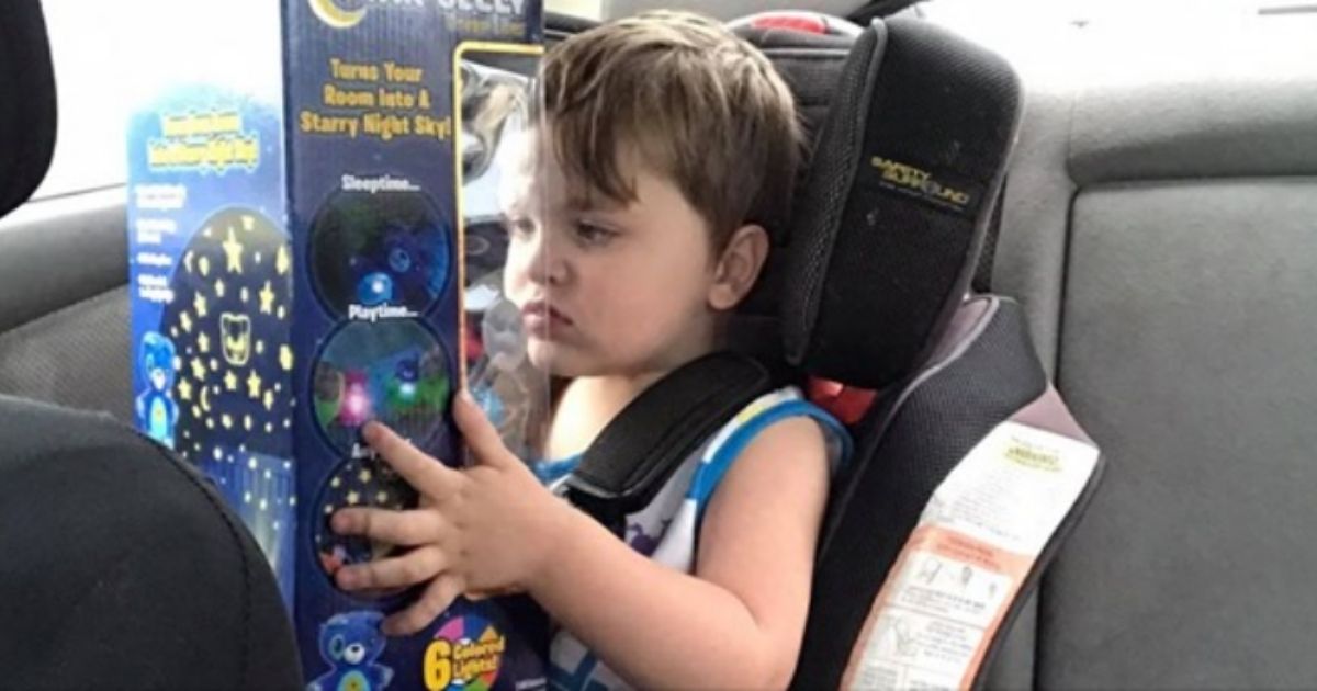 Norris, a 3-year-old with autism, holds a toy that a stranger gifted him after he broke down at the store.