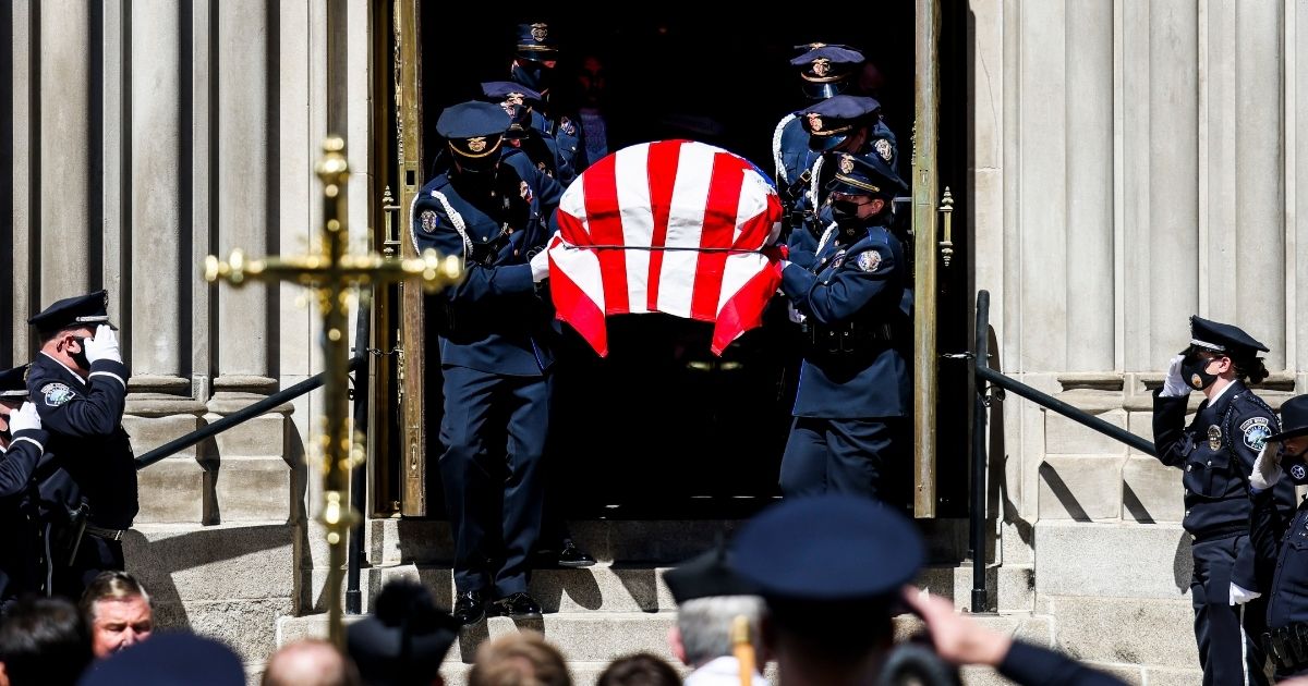 Police officers carry the body of slain Boulder police officer Eric Talley to a hearse after a funeral mass at the Cathedral Basilica of the Immaculate Conception in Denver on March 29.