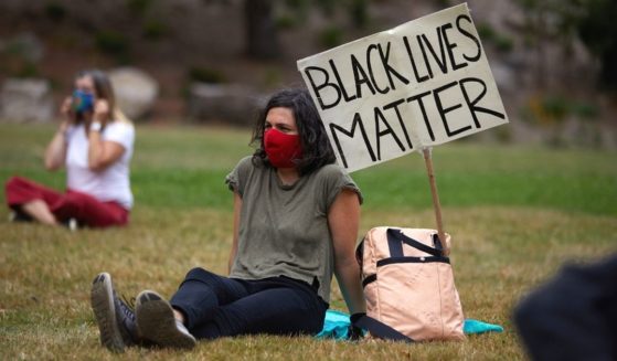 People wear masks as they gather at Lents Park in Portland, Oregon, on Sept. 5, 2020, to mark the 100th day of protests in the city against racism and police brutality.