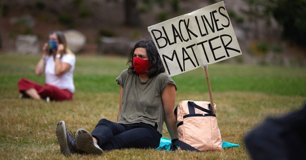 People wear masks as they gather at Lents Park in Portland, Oregon, on Sept. 5, 2020, to mark the 100th day of protests in the city against racism and police brutality.