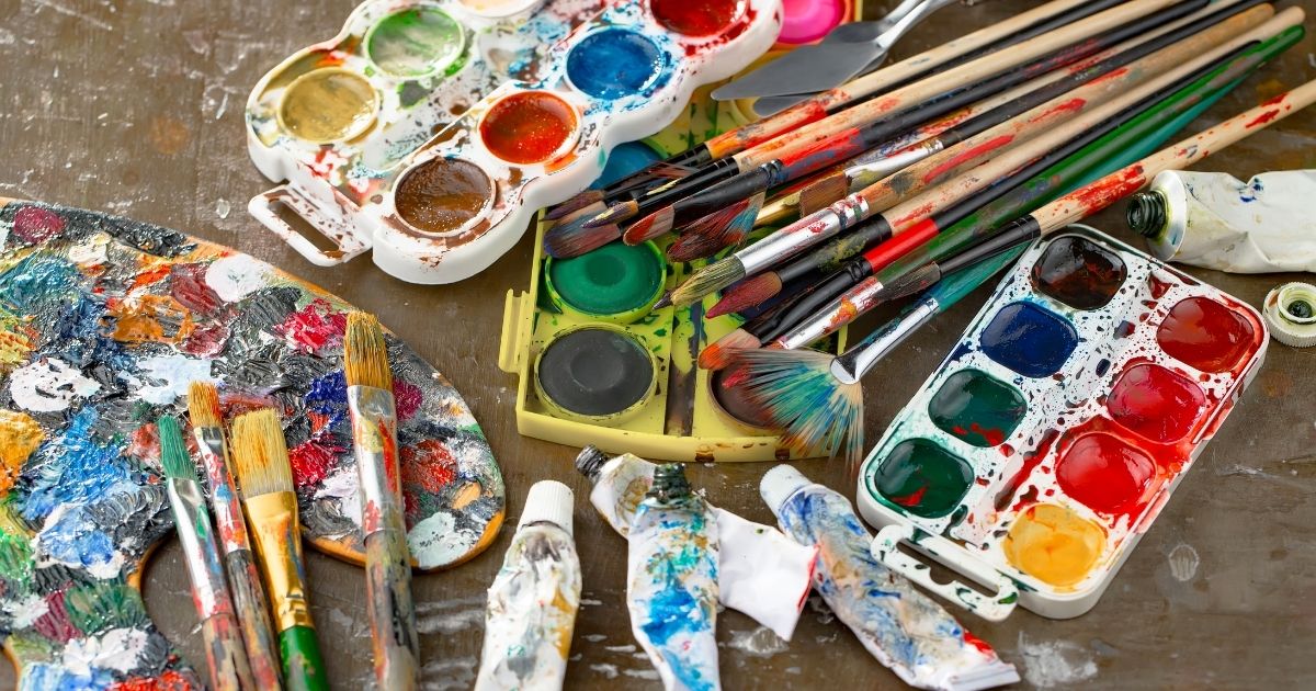 Paints and brushes are pictured in the stock image above.
