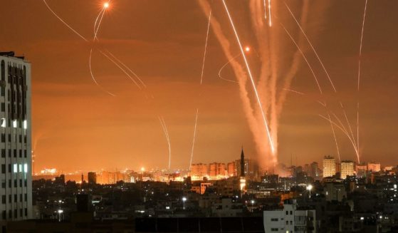 Rockets light up the night sky as they are fired towards Israel from Beit Lahia in the northern Gaza Strip on Friday local time.