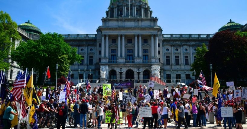 Demonstrators rally outside the Pennsylvania Capitol Building to protest the continued closure of businesses due to the coronavirus pandemic on May 15, 2020, in Harrisburg, Pennsylvania.