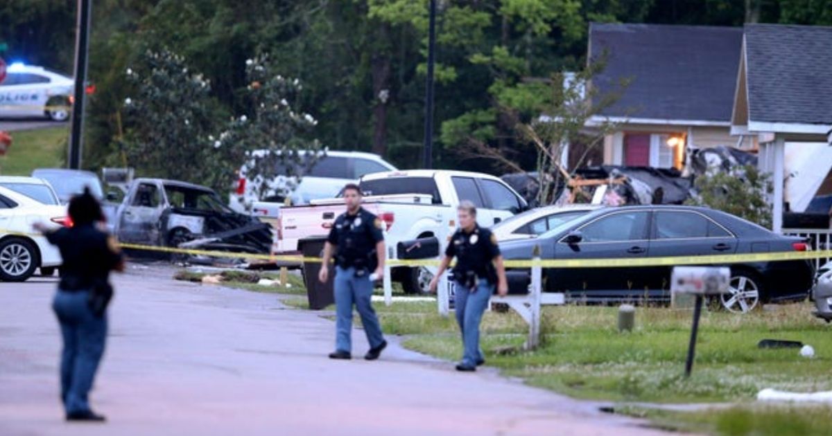 Investigators visit a house in Hattiesburg, Mississippi, where a plane crashed on Tuesday.