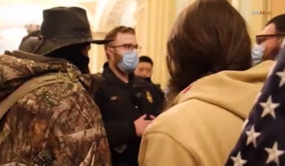A police officer talks to protesters inside the U.S. Capitol in Washington on Jan. 6.