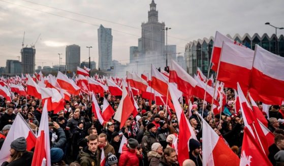 People wave national flags during a march to mark Poland's National Independence Day on Nov. 11, 2019, in Warsaw.