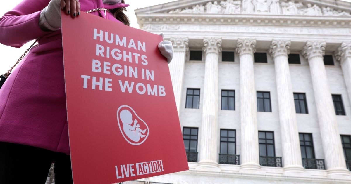 A pro-life activist holds a sign outside the U.S. Supreme Court during the 48th annual March for Life Jan. 29 in Washington, D.C.