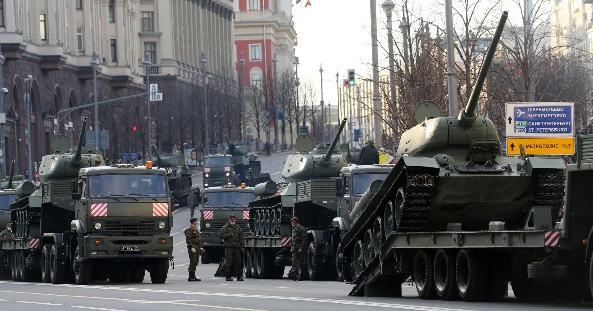 The Russian military drives heavy trucks carrying Soviet T-34 tanks during the first city rehearsals of the Victory Day military parade on April 29, 2021, in Moscow, Russia.