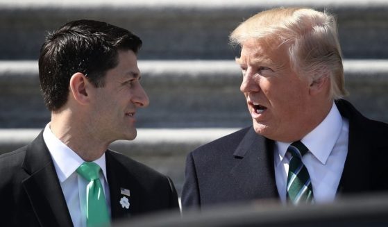 Then-President Donald Trump talks to then-House Speaker Paul Ryan following a luncheon celebrating St. Patrick's Day at the U.S. Capitol on March 16, 2017.