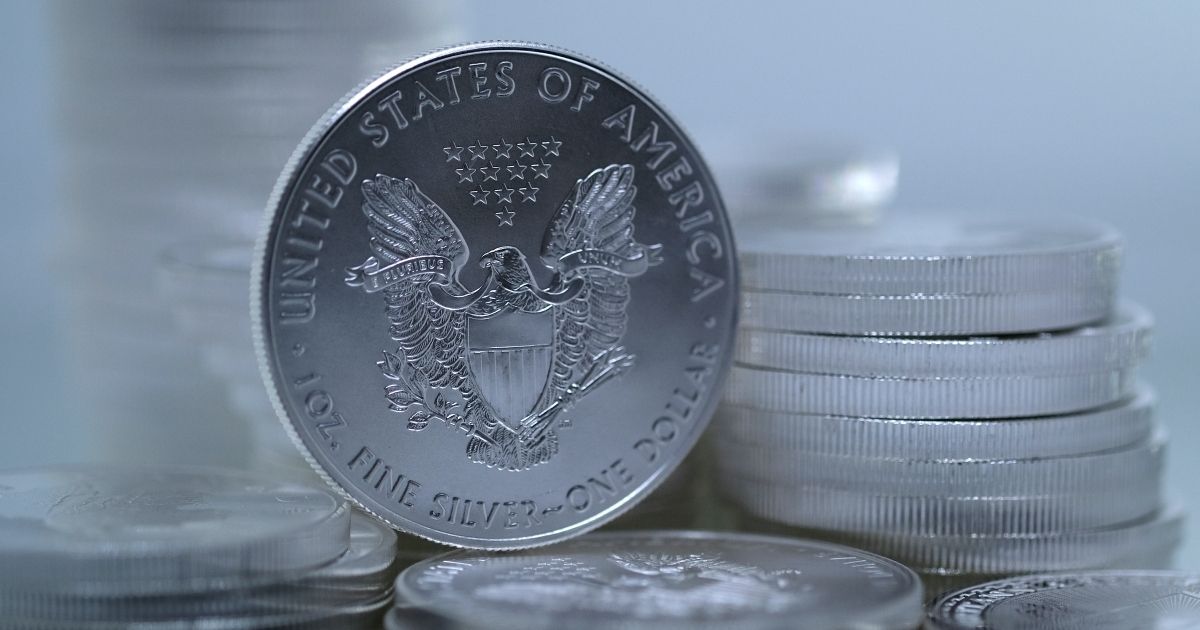 In this photo illustration, one-ounce American Silver Eagle bullion coin is placed among one-ounce silver bullion coins on March 14.