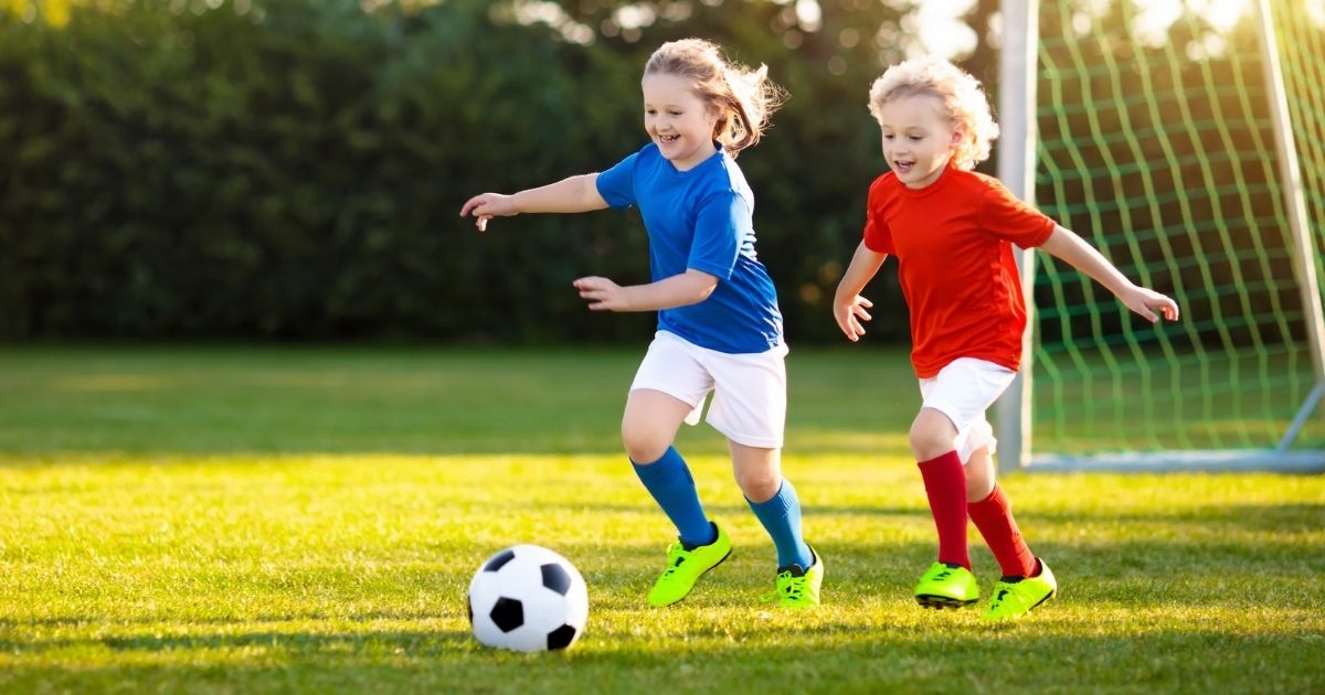 Two children are pictured playing soccer in the stock image above.