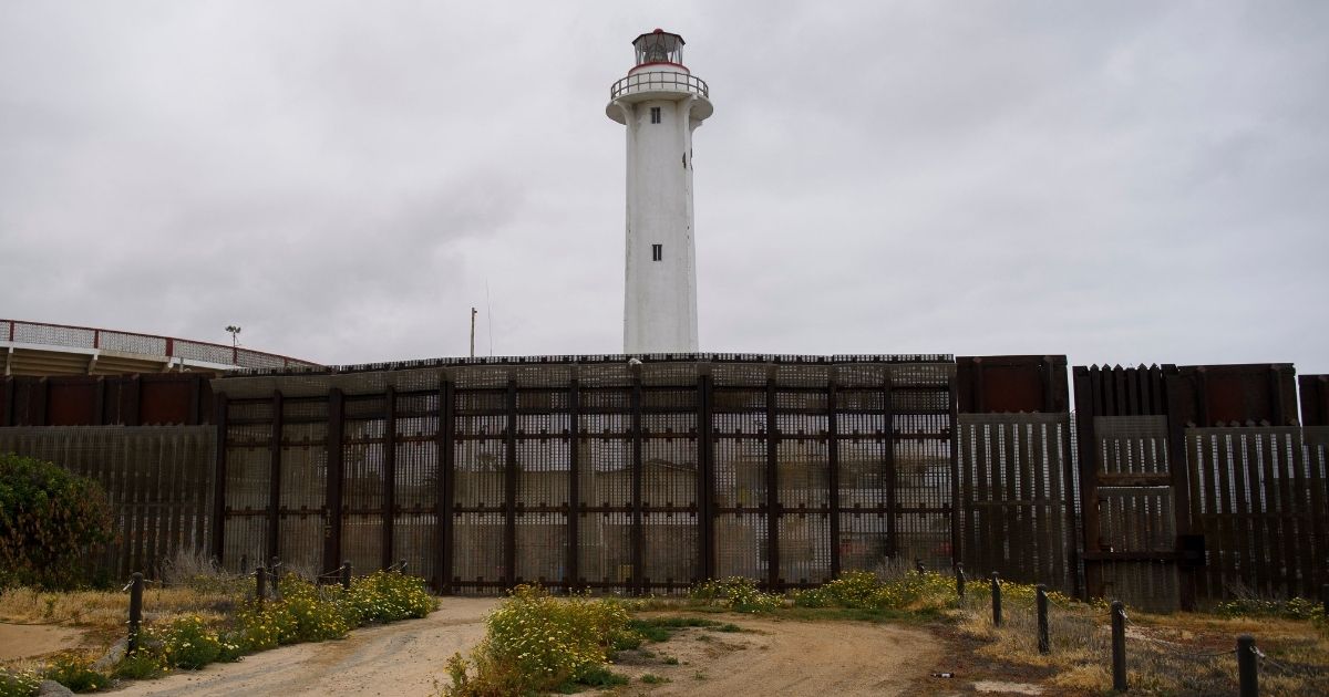 The Faro de Playas de Tijuana lighthouse stands behind the border wall where it ends in the Pacific Ocean along the U.S.-Mexico border between San Diego and Tijuana on Monday at International Friendship Park in San Diego County, California.
