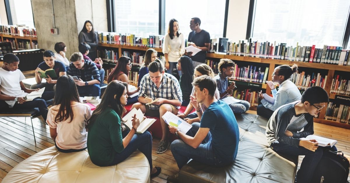 Students are pictured studying in a library in the stock image above.