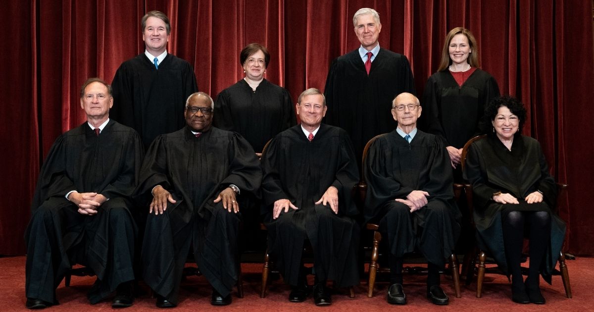 Members of the Supreme Court pose for a group photo at the Supreme Court in Washington on April 23.