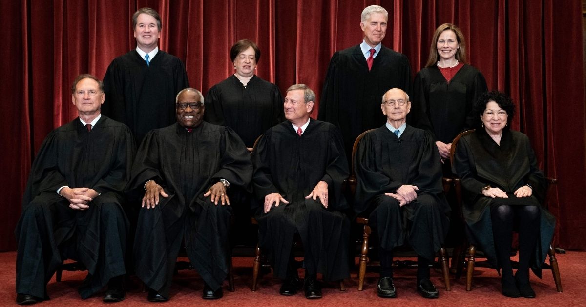 Justices pose for a group photo of the Supreme Court in Washington on April 23. Seated, from left, are Associate Justice Samuel Alito, Associate Justice Clarence Thomas, Chief Justice John Roberts, Associate Justice Stephen Breyer and Associate Justice Sonia Sotomayor. Standing, from left, are Associate Justice Brett Kavanaugh, Associate Justice Elena Kagan, Associate Justice Neil Gorsuch and Associate Justice Amy Coney Barrett.