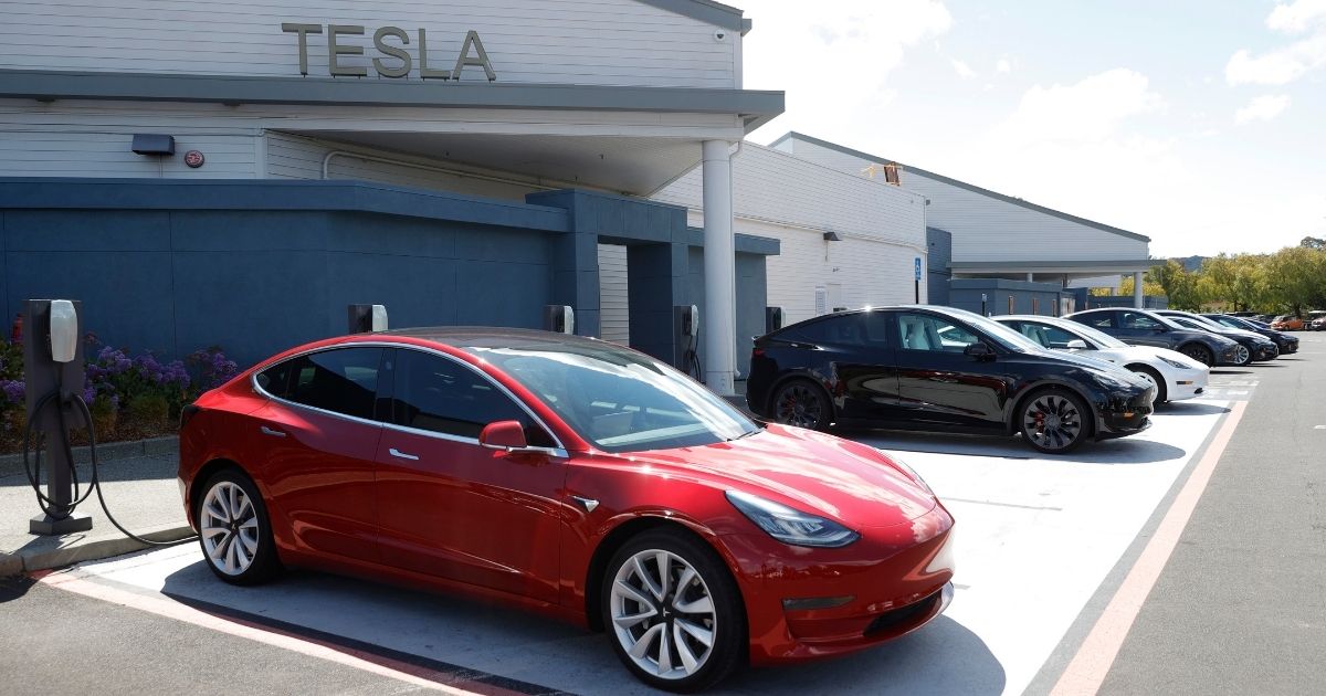 Tesla cars charge at a Tesla charging station on April 26, 2021, in Corte Madera, California.