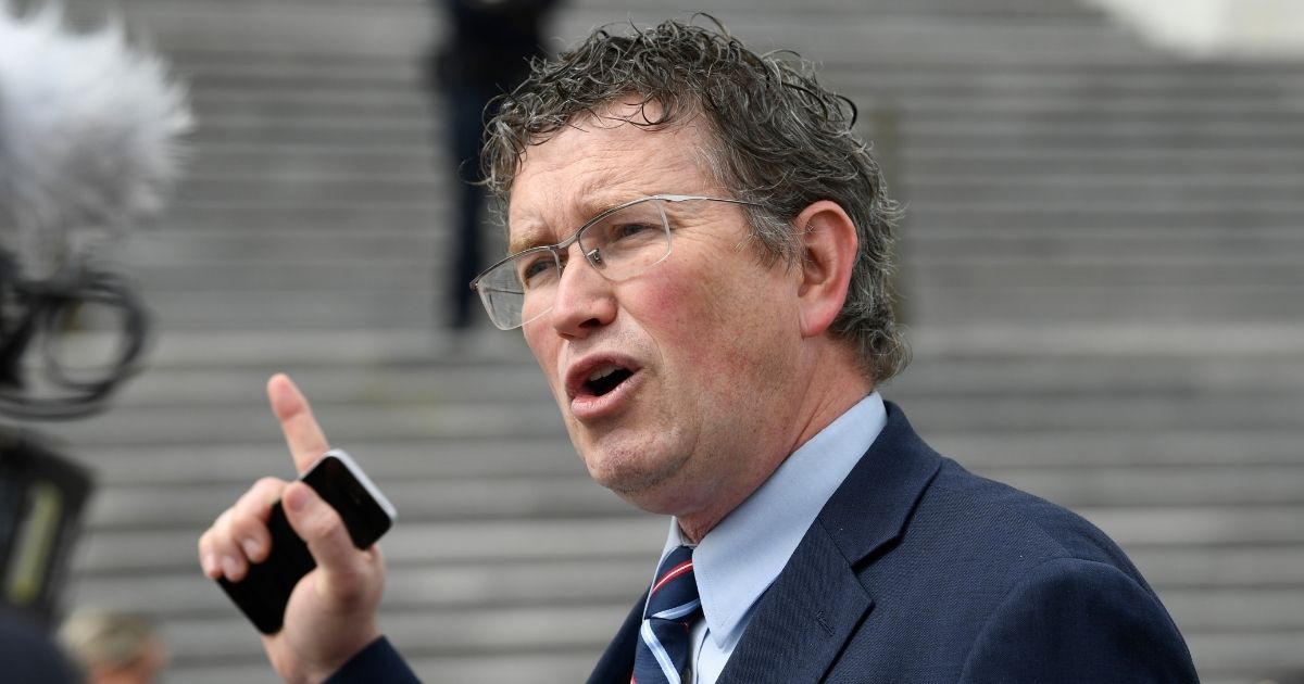 In this March 27, 2020, file photo Kentucky GOP Rep. Thomas Massie talks to reporters before leaving Capitol Hill in Washington.