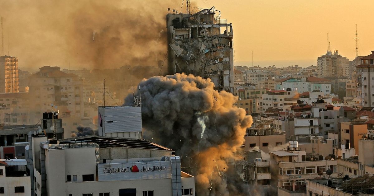 Heavy smoke and fire rise from Al-Sharouk tower as it collapses after being hit by an Israeli air strike in Gaza City on Wednesday.