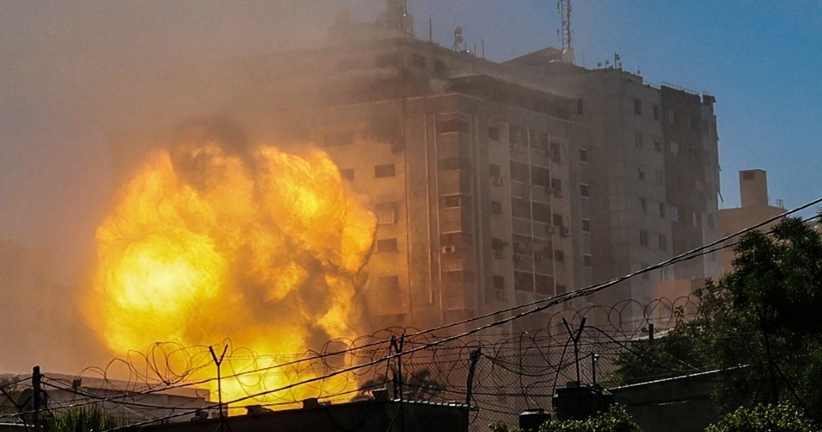 A ball of fire erupts from the Jala Tower as it is destroyed in an Israeli airstrike in Gaza City on Saturday.