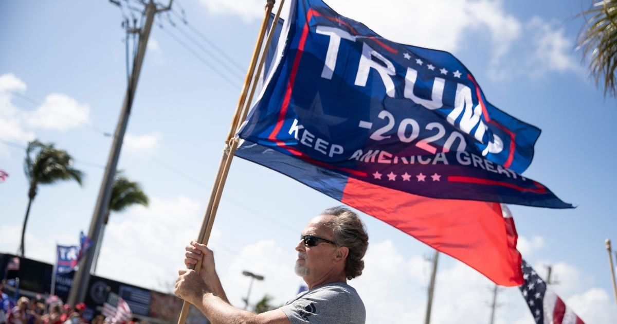 Donald trump walk during a rally near his Mar-a-Lago Estate on Feb. 15, 2021 in West Palm Beach, Florida.