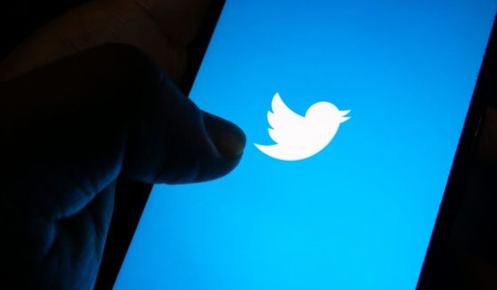 The Twitter logo is pictured on a smartphone screen in the stock image above.