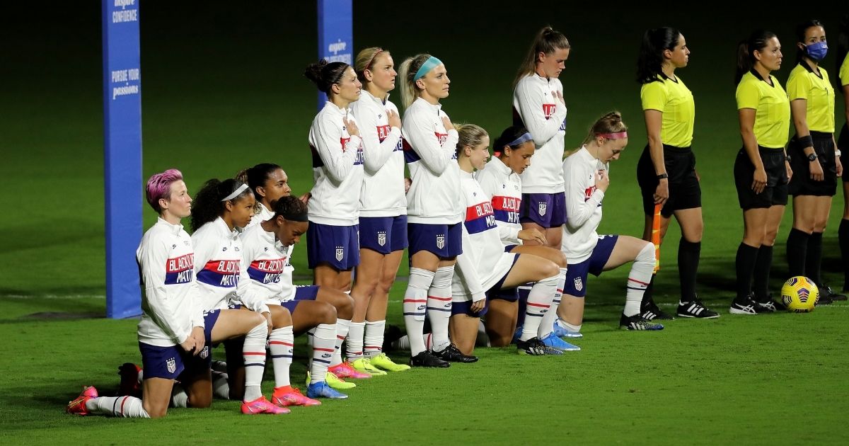 United States players kneel for the American national anthem during the SheBelieves Cup at Exploria Stadium on February 18, in Orlando, Florida.