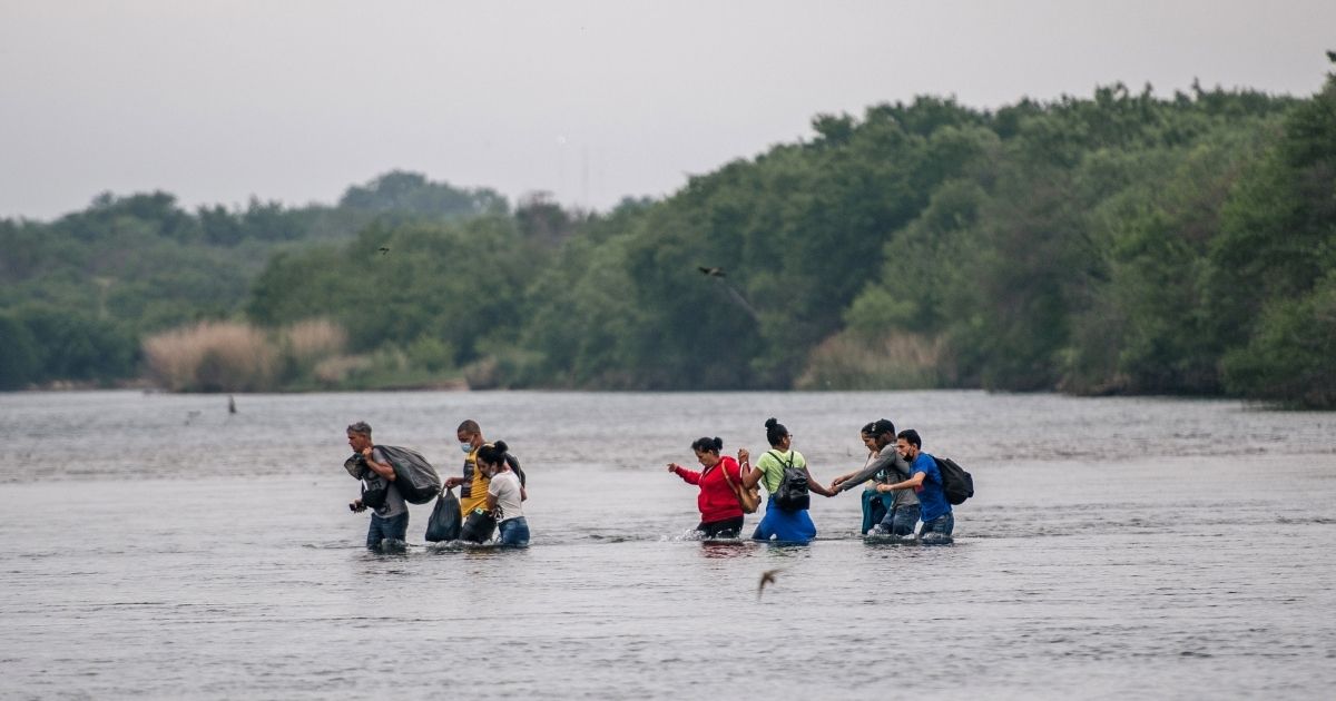 Immigrants cross the Rio Grande from Mexico into Del Rio, Texas, on Monday.