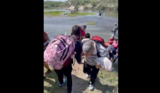 Immigrants are pictured crossing the Rio Grande in Del Rio, Texas, on May 9.
