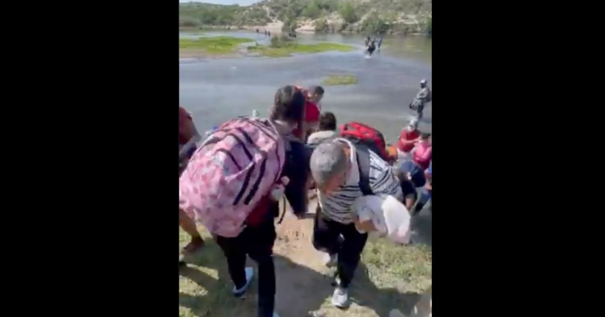 Immigrants are pictured crossing the Rio Grande in Del Rio, Texas, on May 9.