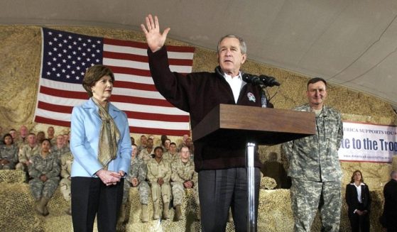 Then-President George W. Bush, right, speaks to U.S. and coalition troops on March 1, 2006, as then-first lady Laura Bush looks on at Bagram Air Base in Afghanistan.