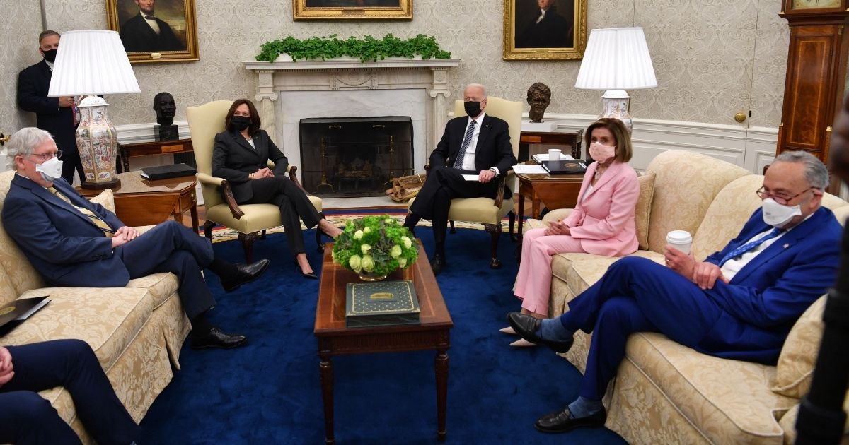 President Joe Biden, center, meets Wednesday in the Oval Office with Senate Minority Leader Mitch McConnell, left, Vice President Kamala Harris, House Speaker Nancy Pelosi and Senate Majority Leader Chuck Schumer. House Minority Leader Kevin McCarthy, not pictured, was seated next to McConnell.
