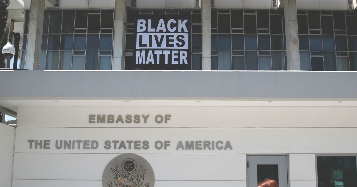 A "Black Lives Matter" banner marking the one-year anniversary of the killing of George Floyd by a Minneapolis police officer hangs from the U.S. Embassy in Athens, Greece, on Tuesday.