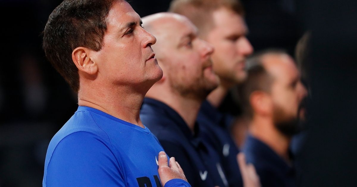 Mark Cuban, billionaire owner of the NBA's Dallas Mavericks, puts his hand over his heart during the playing of a pre-game national anthem in a 2017 file photo.