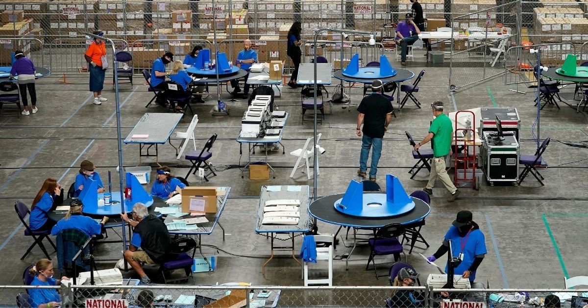 Maricopa County ballots cast in the 2020 general election are examined and recounted by contractors working for Florida-based company, Cyber Ninjas, on Thursday at Veterans Memorial Coliseum in Phoenix.