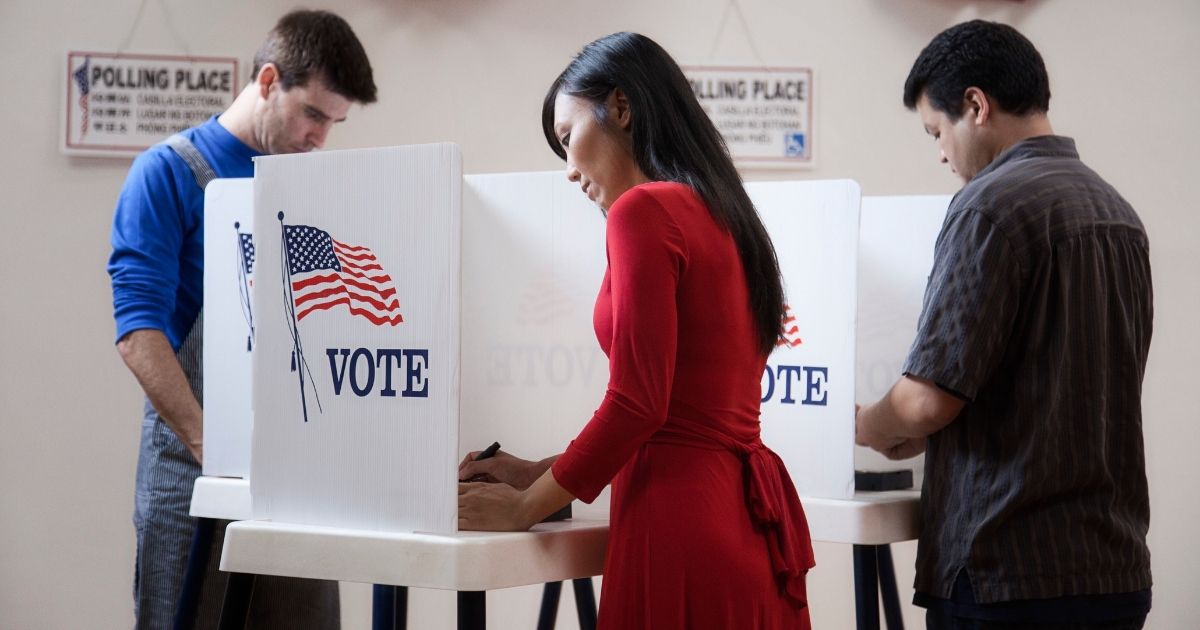 The above stock photo shows voters filling out their ballots.