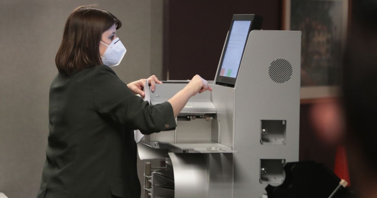 Claire Woodall-Vogg, executive director of the Milwaukee election commission collects the count from absentee ballots from a voting machine on Nov. 4, 2020, in Milwaukee.