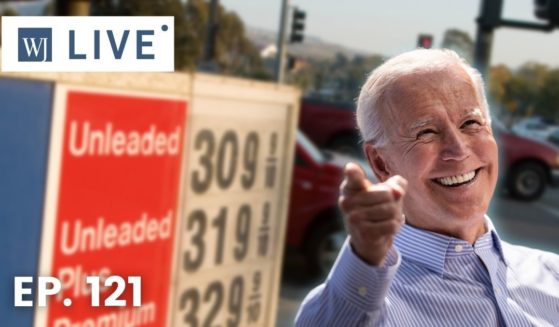 At right, then-Democratic presidential candidate Joe Biden speaks in Philadelphia on May 18, 2019. At left is a sign showing high gas prices.