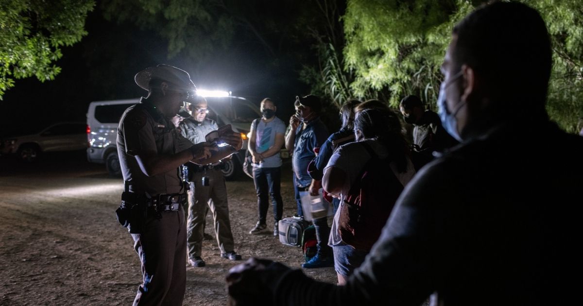 Venezuelan immigrants turn themselves in to Texas state troopers after crossing the border with Mexico on May 18, 2021 in Del Rio, Texas.
