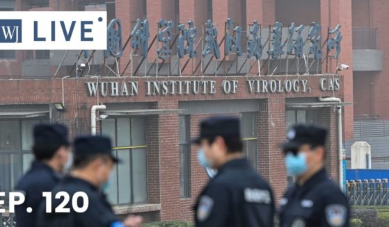 Security personnel stand guard outside the Wuhan Institute of Virology in Wuhan as members of the World Health Organization team investigating the origins of the COVID-19 coronavirus make a visit to the institute in Wuhan in China's central Hubei province on Feb. 3, 2021.