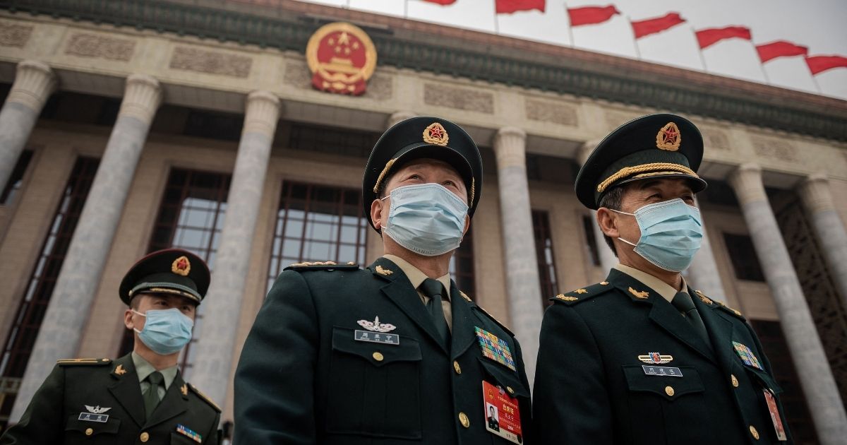 Military delegates leave the Great Hall of the People after the closing session of the National People's Congress in Beijing on March 11, 2021.