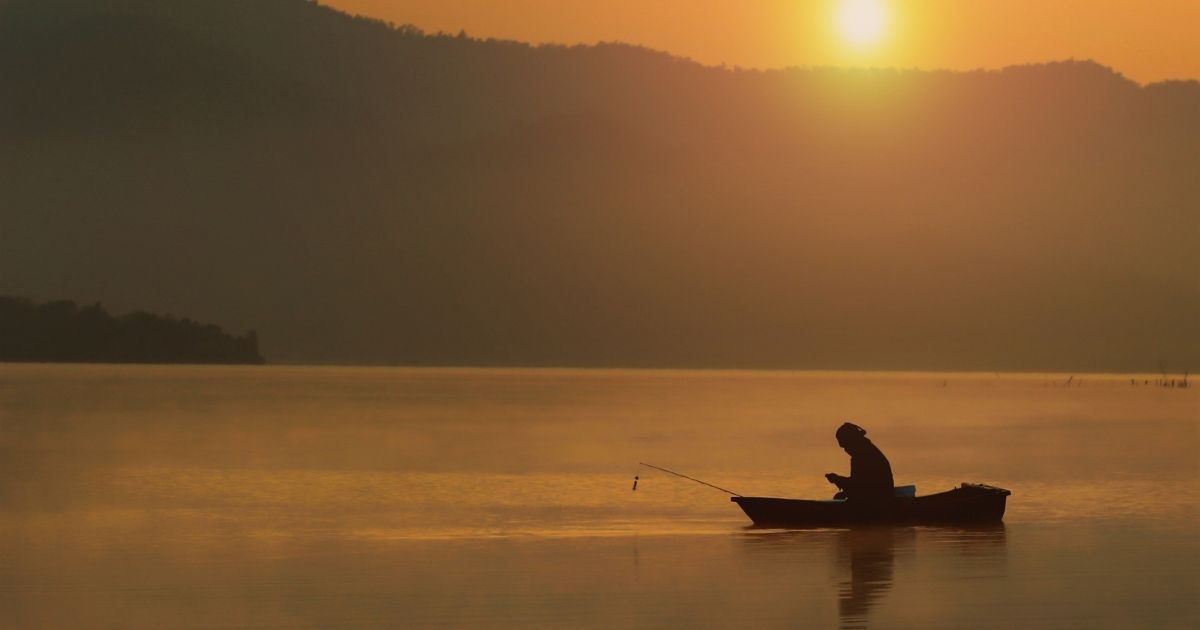 A fisherman fishing on a lake at sunset is seen in the stock image above. One lone fisherman helped rescue a 10-year-old who couldn't swim and fell out of his kayak on Sunday in New York.