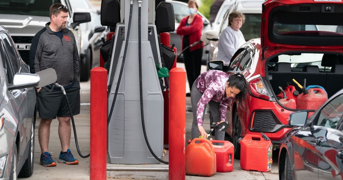 Motorists use gas pumps at a refueling station on Wednesday in Benson, North Carolina.