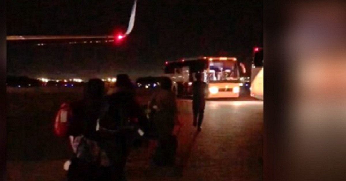 A bus is loaded with apparently illegal immigrant children during a night operation at McGhee Tyson Airport in Knoxville, Tennessee.