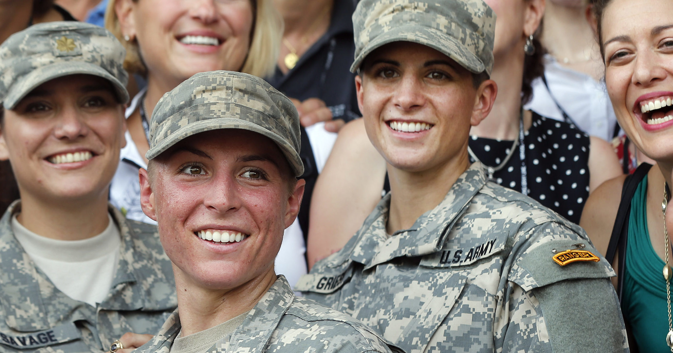 In this Aug. 21, 2015, file photo, Army 1st Lt. Shaye Haver, center, and Capt. Kristen Griest, right, pose for photos with other female West Point alumni after an Army Ranger school graduation ceremony at Fort Benning, Georgia. Haver and Griest became the first female graduates of the Army's rigorous Ranger School.