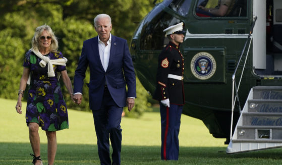 President Joe Biden and first lady Jill Biden walk on the South Lawn of the White House after stepping off Marine One on Sunday in Washington.