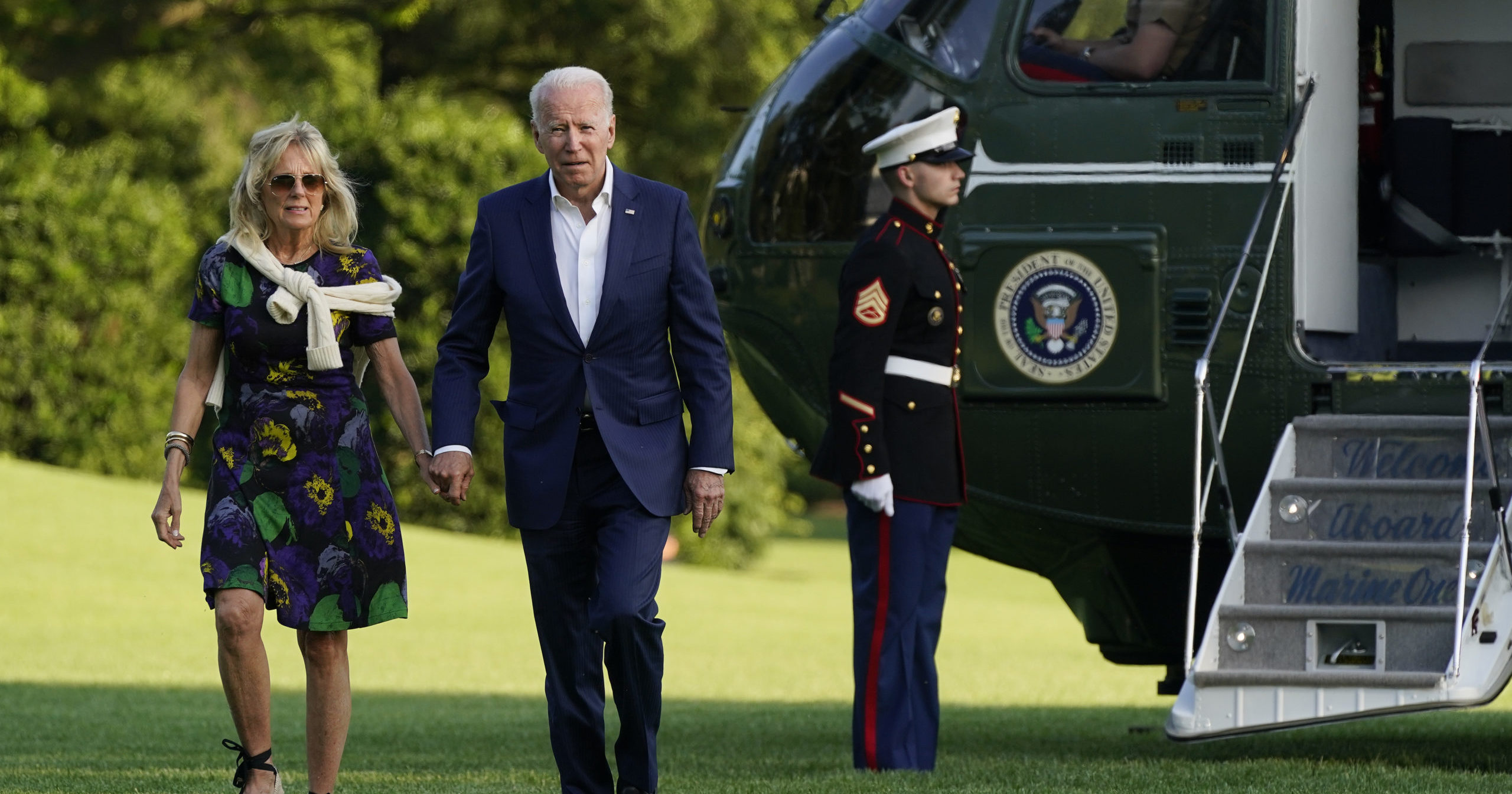 President Joe Biden and first lady Jill Biden walk on the South Lawn of the White House after stepping off Marine One on Sunday in Washington.
