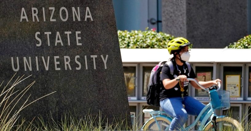 A cyclist crosses an intersection on the campus of Arizona State University on Sept. 1, 2020, in Tempe, Arizona.