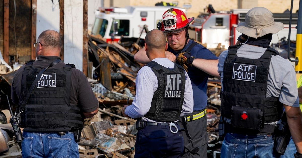 ATF agents look over the damage at an office supply company that was burned during a protest Tuesday, Aug. 25, 2020, in Kenosha, Wisconsin