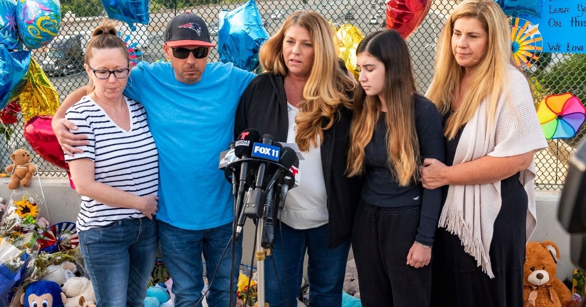In this May 25 file photo, family members of 6-year-old Aiden Leos stand at a makeshift memorial on the Walnut Avenue overpass at the 55 Freeway in Orange, California, to announce that the reward for information leading to the suspects in the road-rage shooting death of Leos. Family members and friends tearfully remembered Leos, who was shot and killed in the incident on a Southern California freeway, at his memorial service on Saturday.