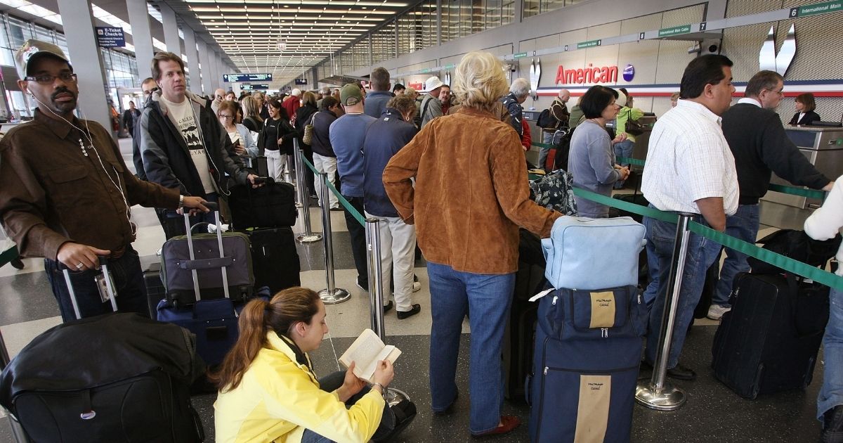 Passengers wait in line to check in for American Airlines flights at O'Hare Airport on April 9, 2008, in Chicago, Illinois.